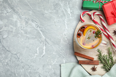 Photo of Aromatic mulled wine on grey marble table, flat lay. Space for text