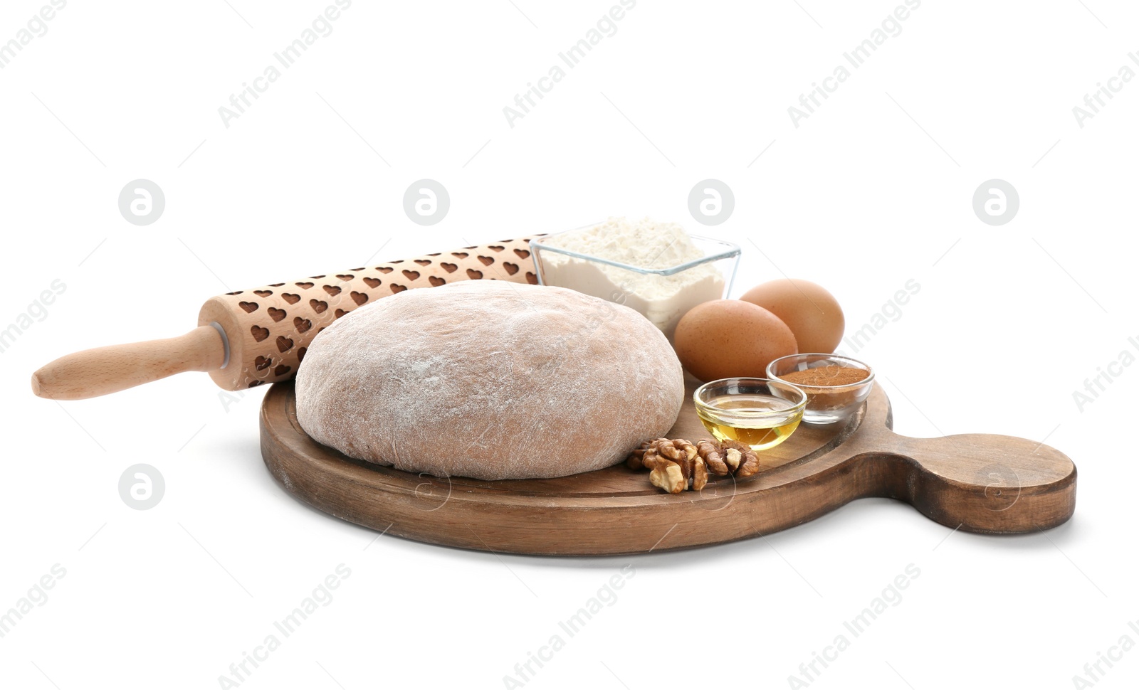 Photo of Wooden board with raw rye dough and ingredients on white background