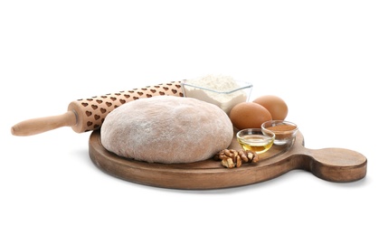 Photo of Wooden board with raw rye dough and ingredients on white background