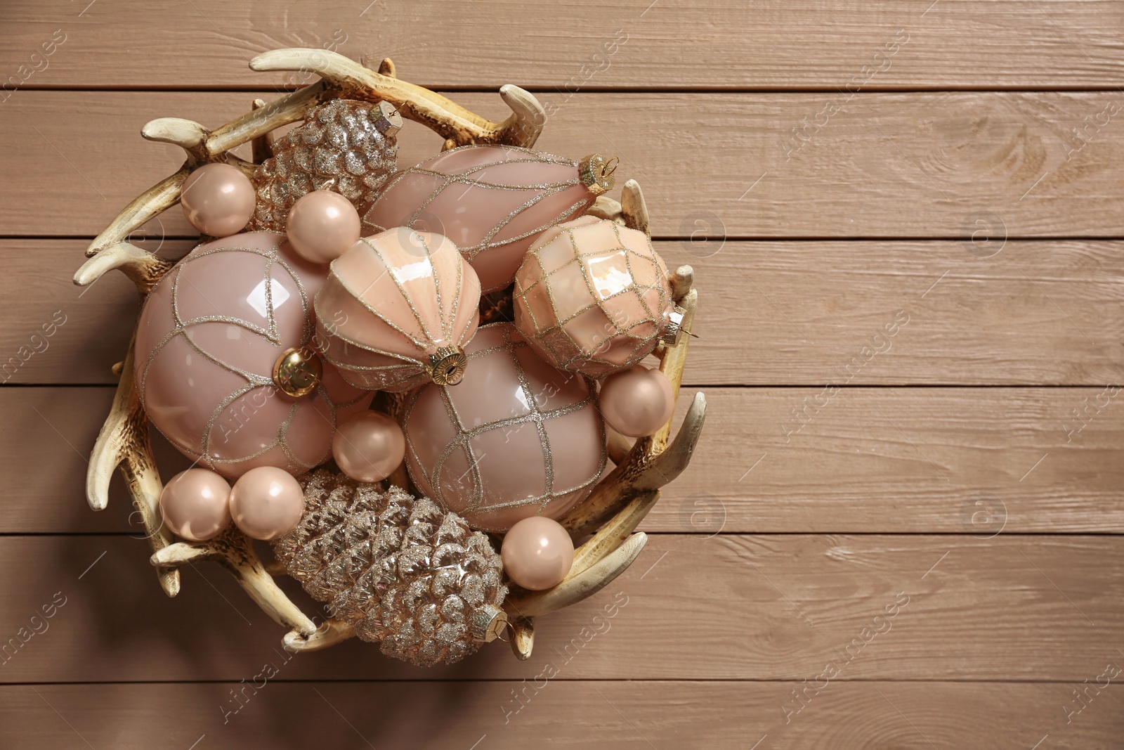 Photo of Collection of beautiful Christmas tree baubles on wooden table, top view. Space for text