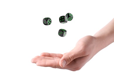 Man throwing black dice on white background, closeup