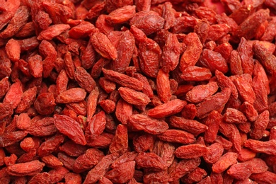 Photo of Many dried goji berries as background, closeup. Healthy superfood