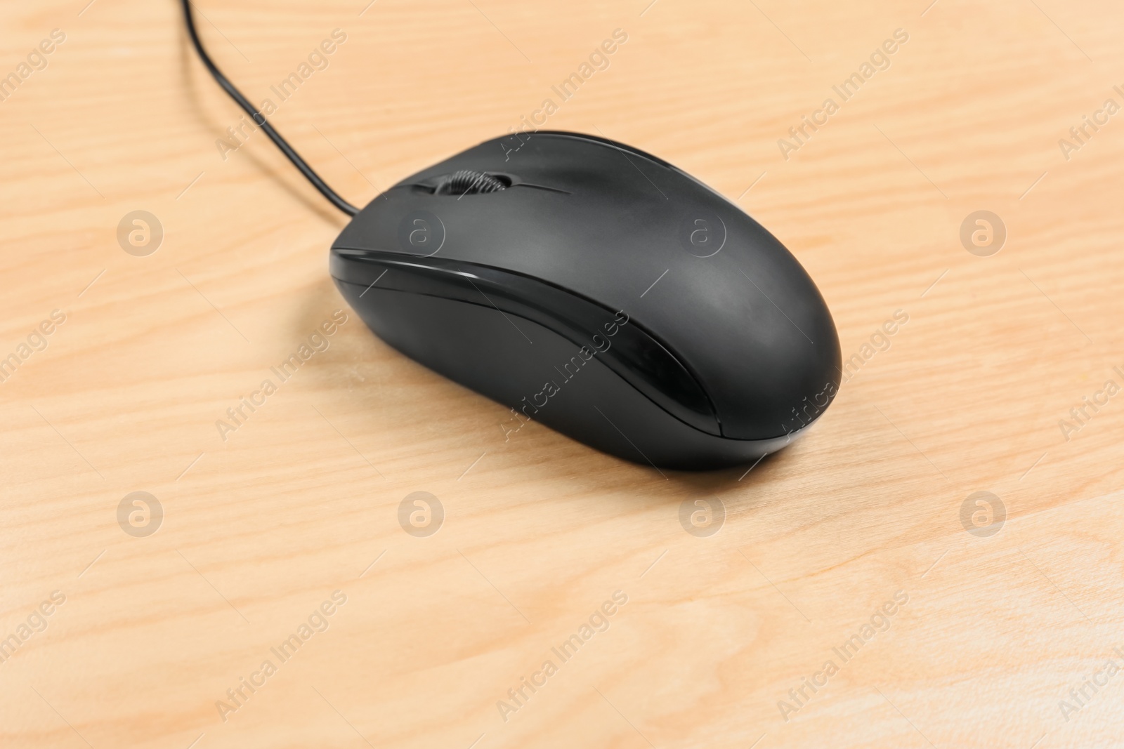 Photo of Modern computer mouse on wooden background