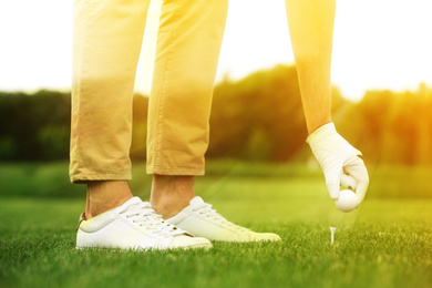 Image of Man playing golf in park on sunny day. Sport and leisure
