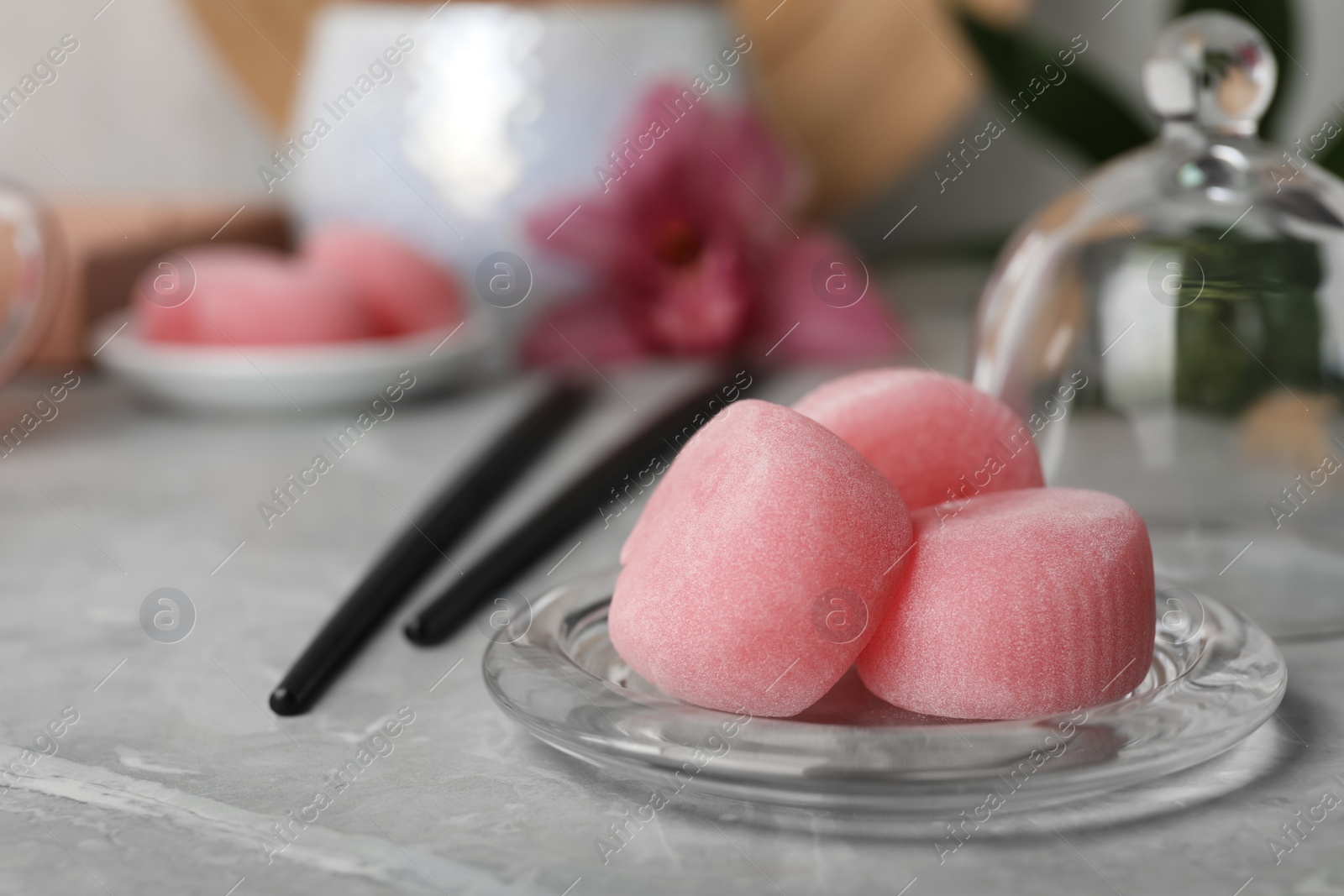 Photo of Delicious mochi on grey table, space for text. Traditional Japanese dessert