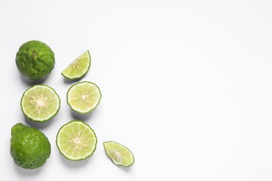 Whole and cut ripe bergamot fruits on white background, flat lay. Space for text