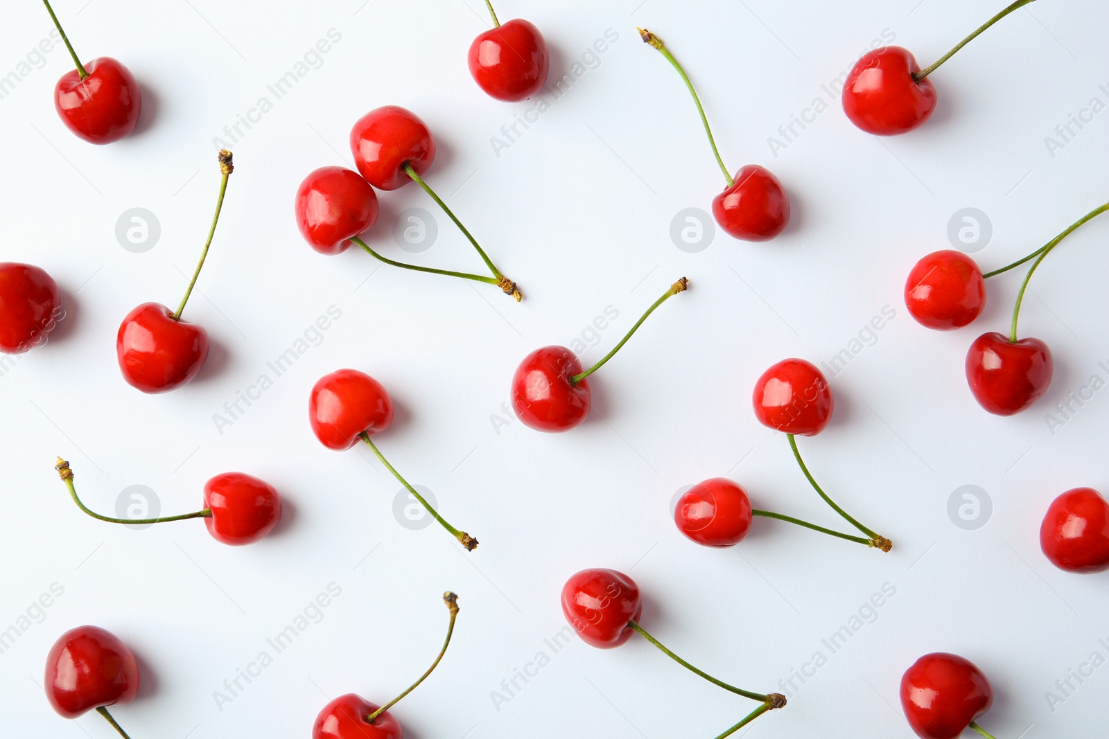 Photo of Ripe red cherries on light background, top view