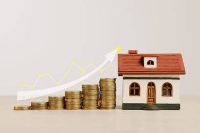 Image of Mortgage rate. Model of house, stacked coins, graph and arrow