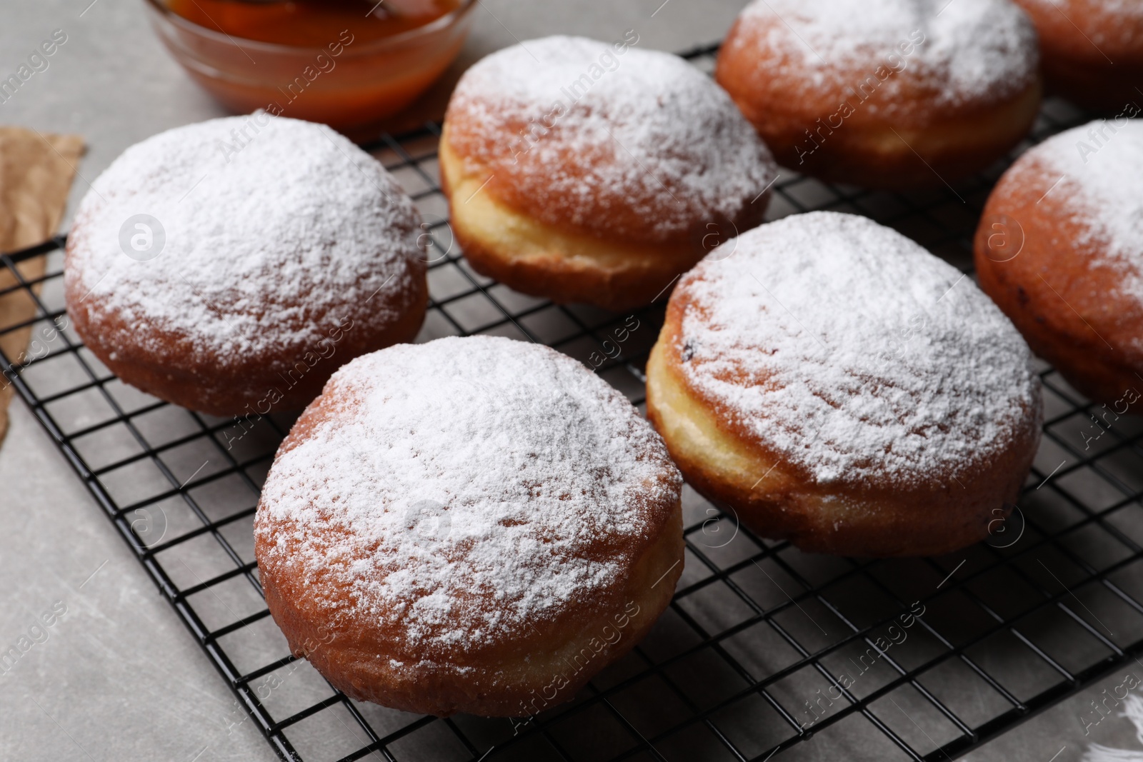 Photo of Delicious sweet buns with powdered sugar on table, closeup