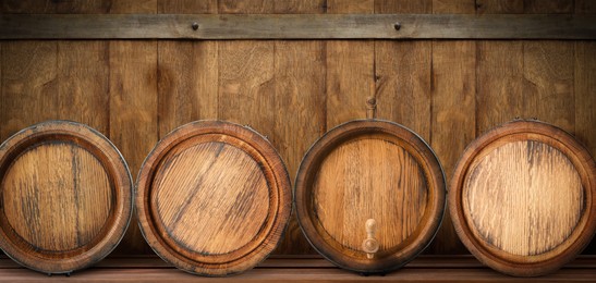 Wooden barrels on shelf, space for text. Banner design