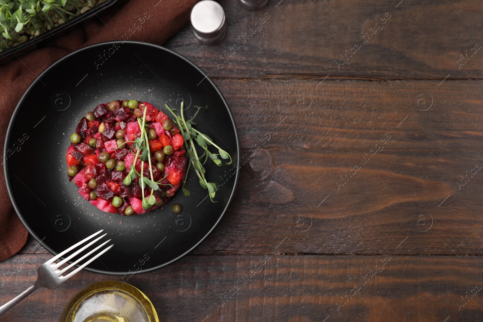 Photo of Delicious vinaigrette salad on wooden table, flat lay. Space for text