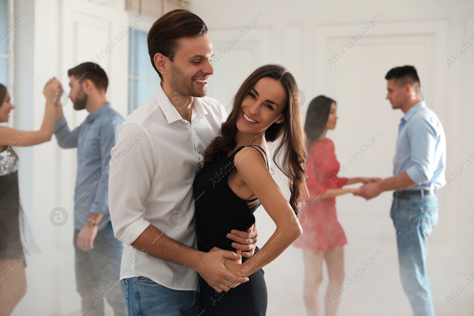 Photo of Lovely young couple dancing together at party