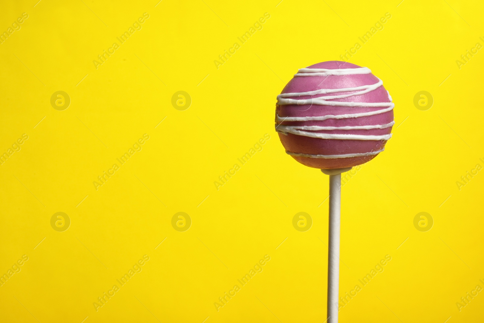 Photo of Bright delicious cake pop on color background. Space for text