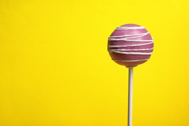 Bright delicious cake pop on color background. Space for text