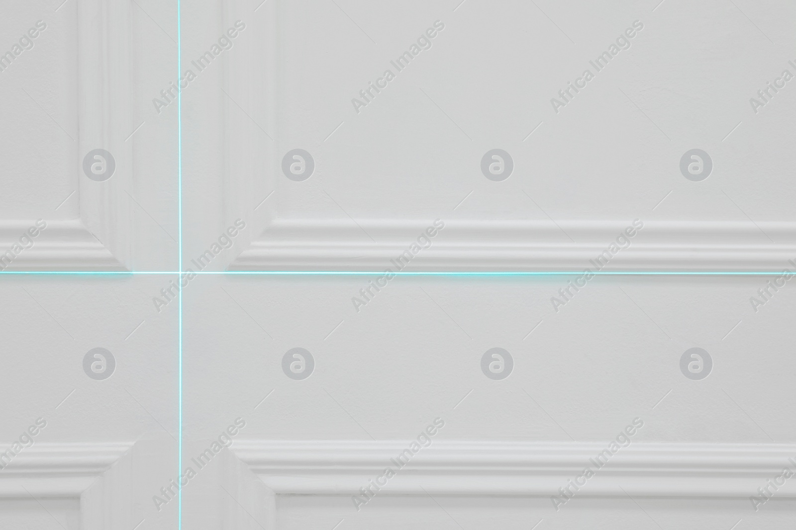 Photo of Cross lines of laser level on white wall