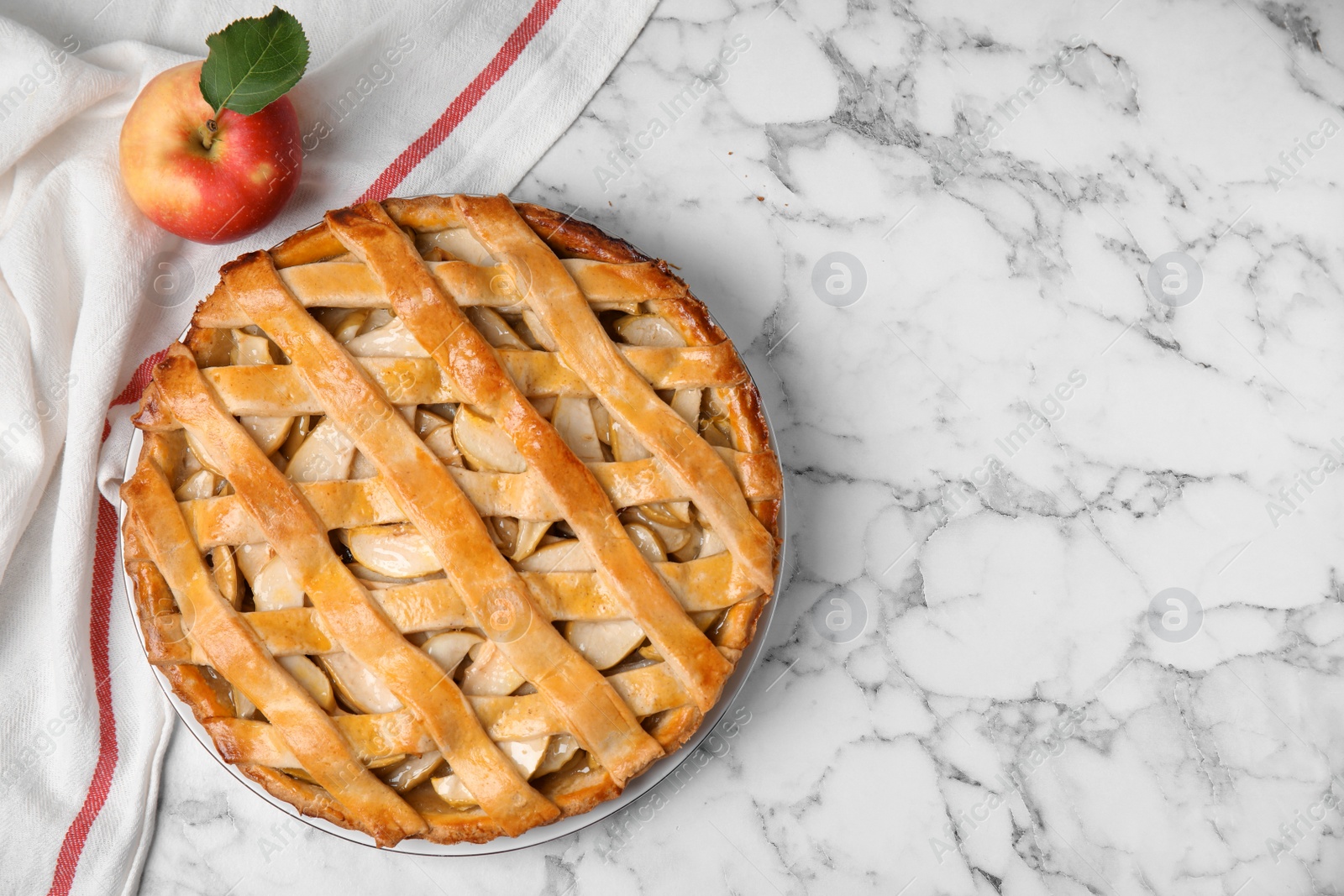 Photo of Delicious traditional apple pie on white marble table, flat lay. Space for text