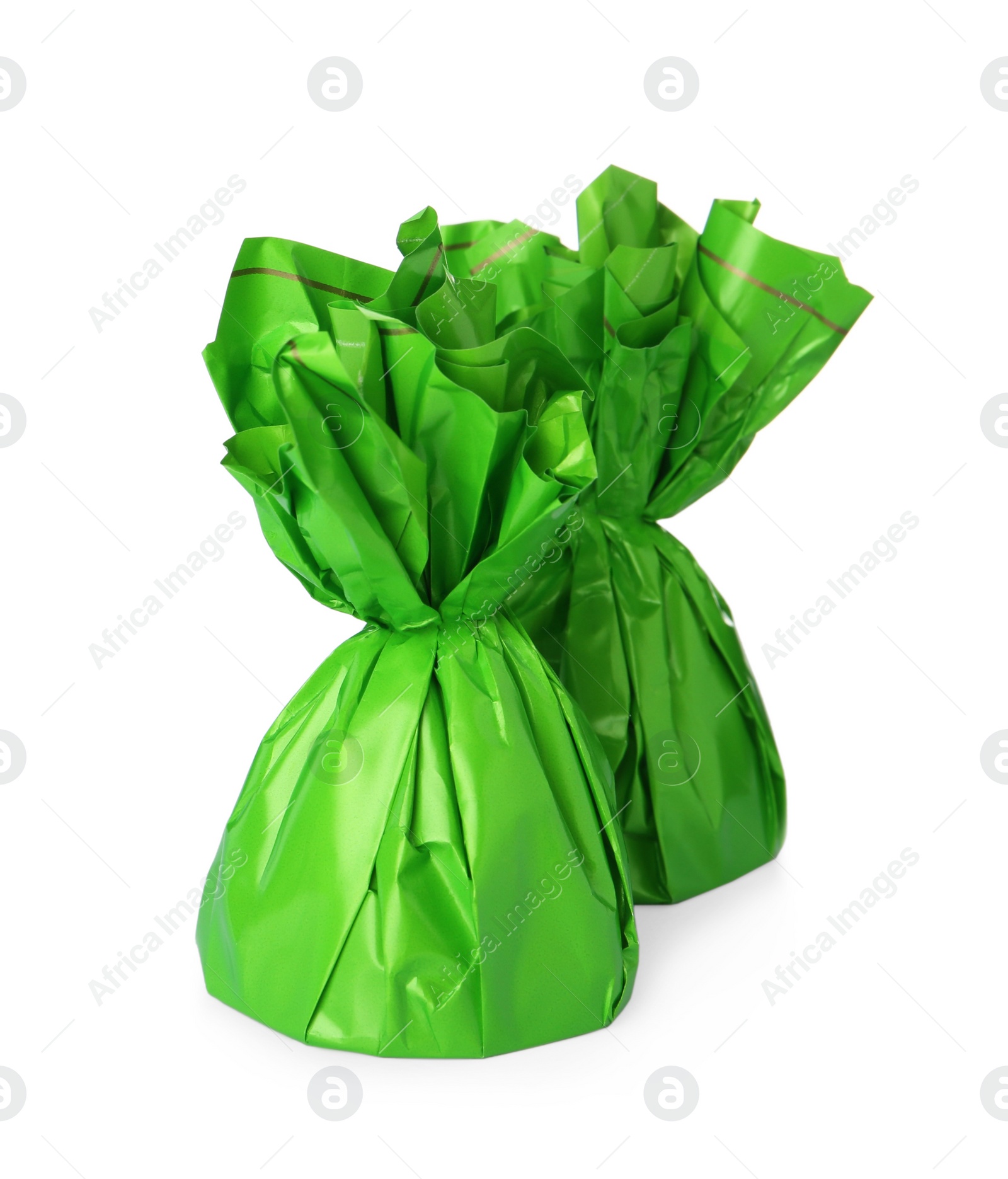 Photo of Delicious candies in green wrappers on white background