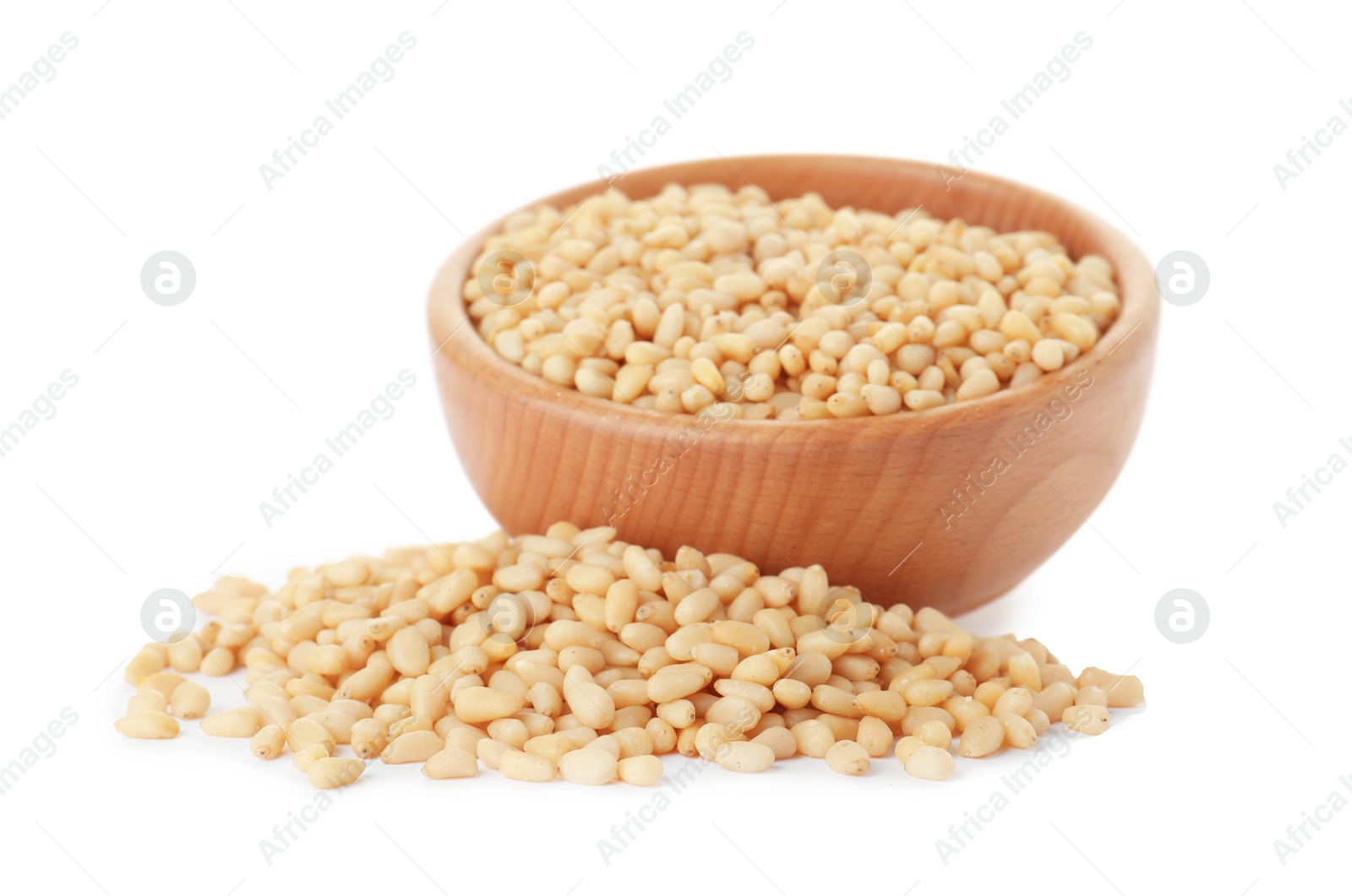 Photo of Pine nuts and bowl on white background
