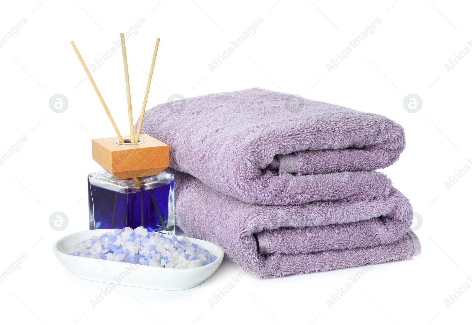 Photo of Spa composition. Towels, sea salt and reed air freshener on white background