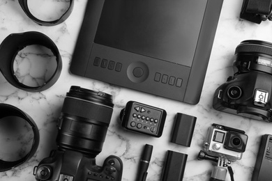 Photo of Flat lay composition with photographer's equipment and accessories on white marble table