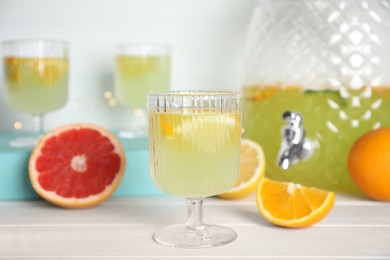 Photo of Delicious refreshing lemonade on white wooden table