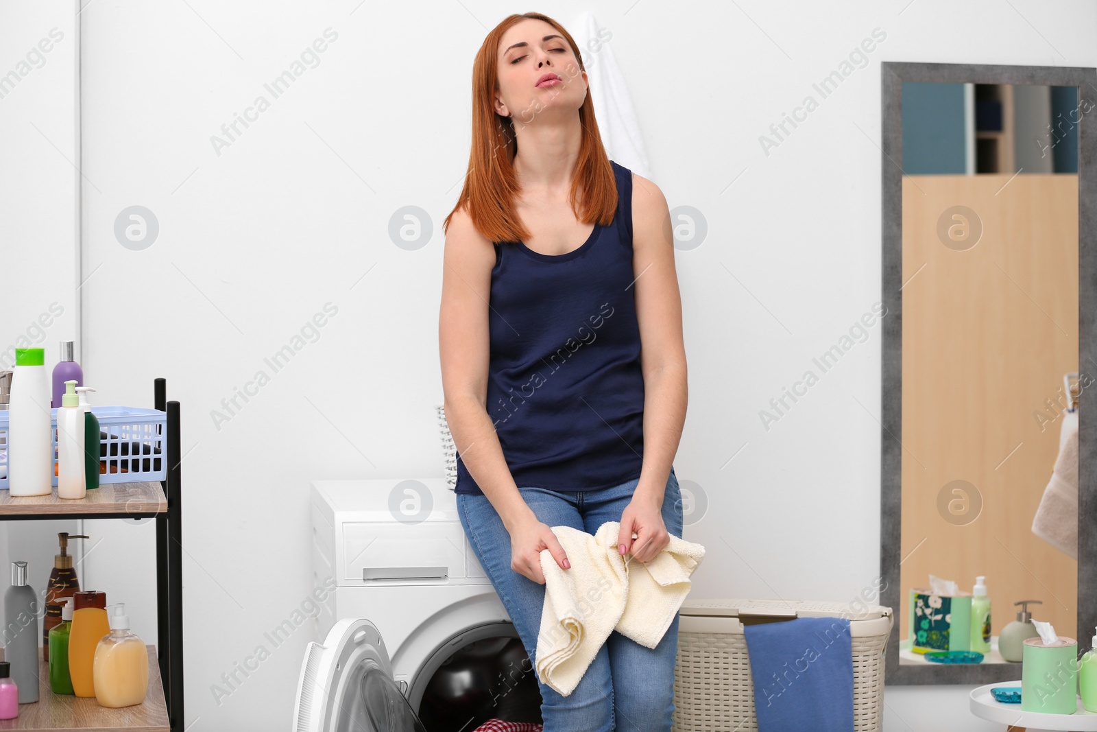 Photo of Tired housewife in laundry room