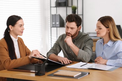 Photo of Couple having meeting with lawyer in office