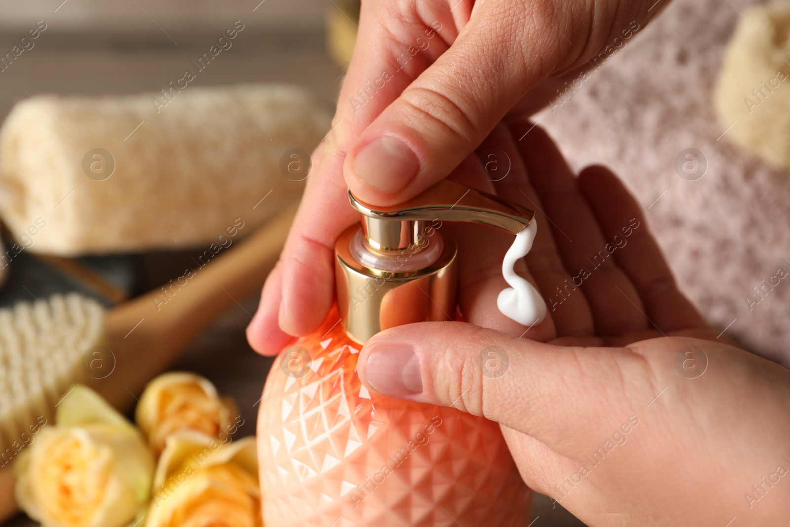 Photo of Woman using liquid soap dispenser, closeup view