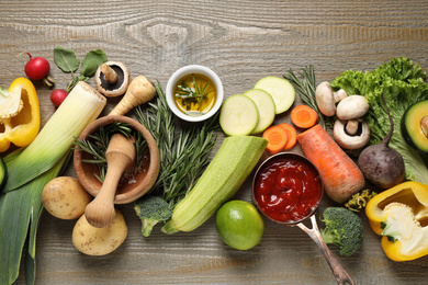 Photo of Fresh products on wooden table, flat lay. Healthy cooking