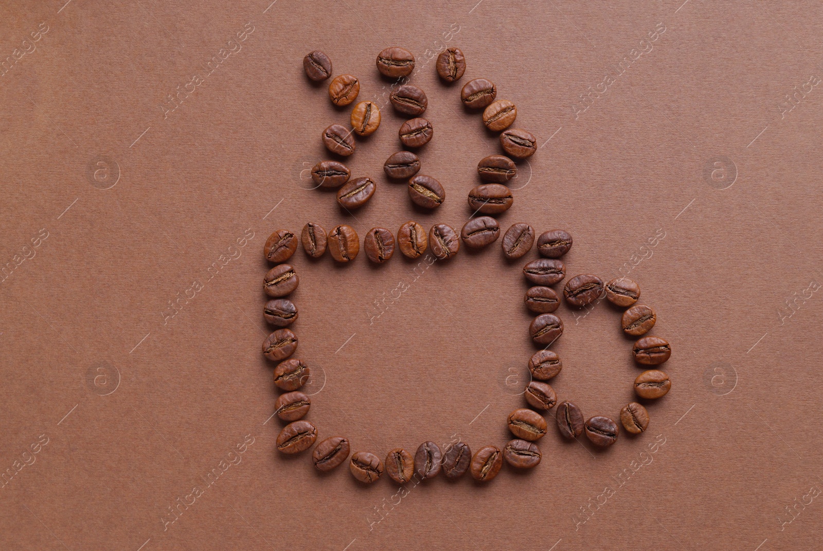 Photo of Cup of hot drink, composition made with coffee beans on brown background, flat lay