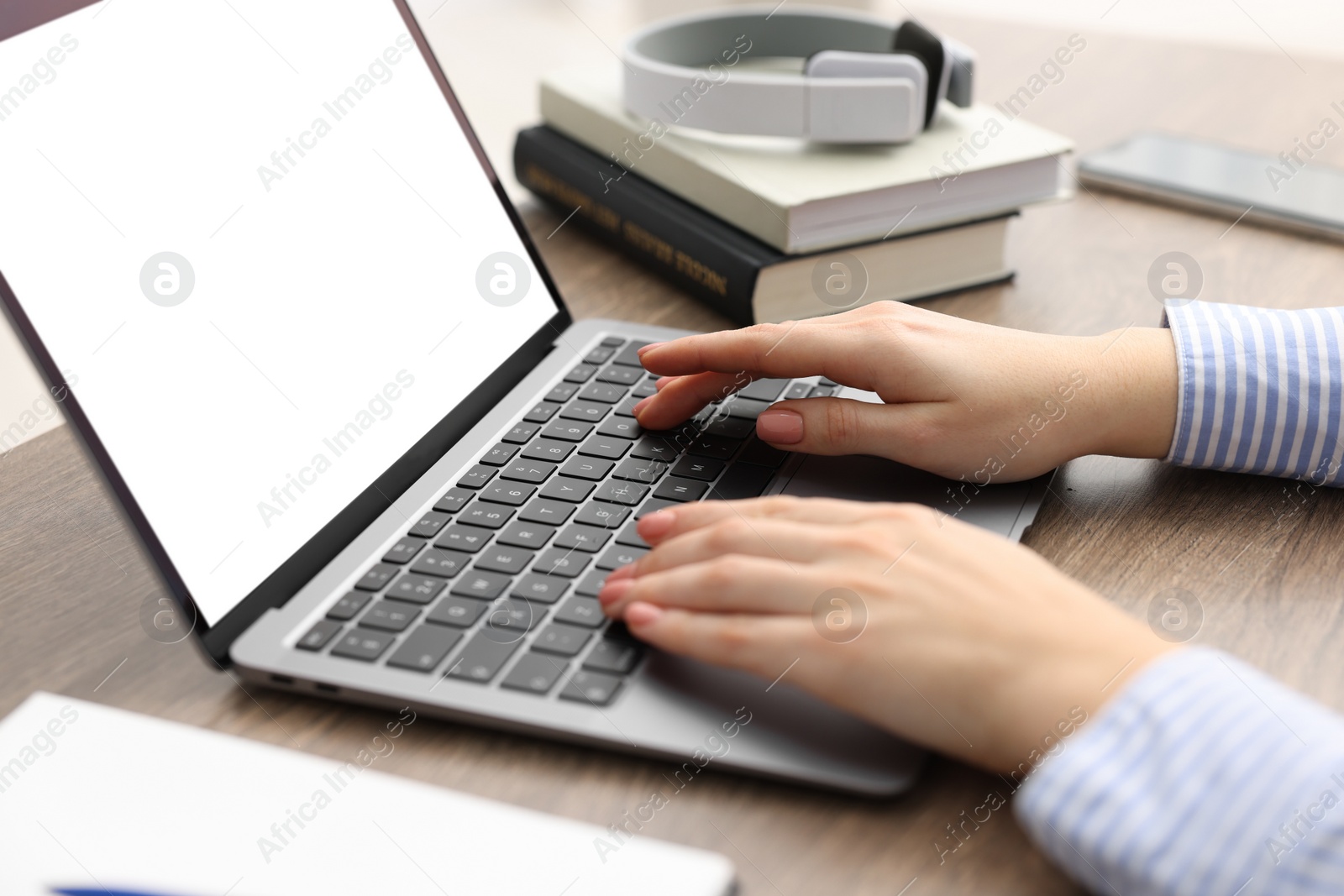 Photo of E-learning. Woman using laptop during online lesson indoors, closeup