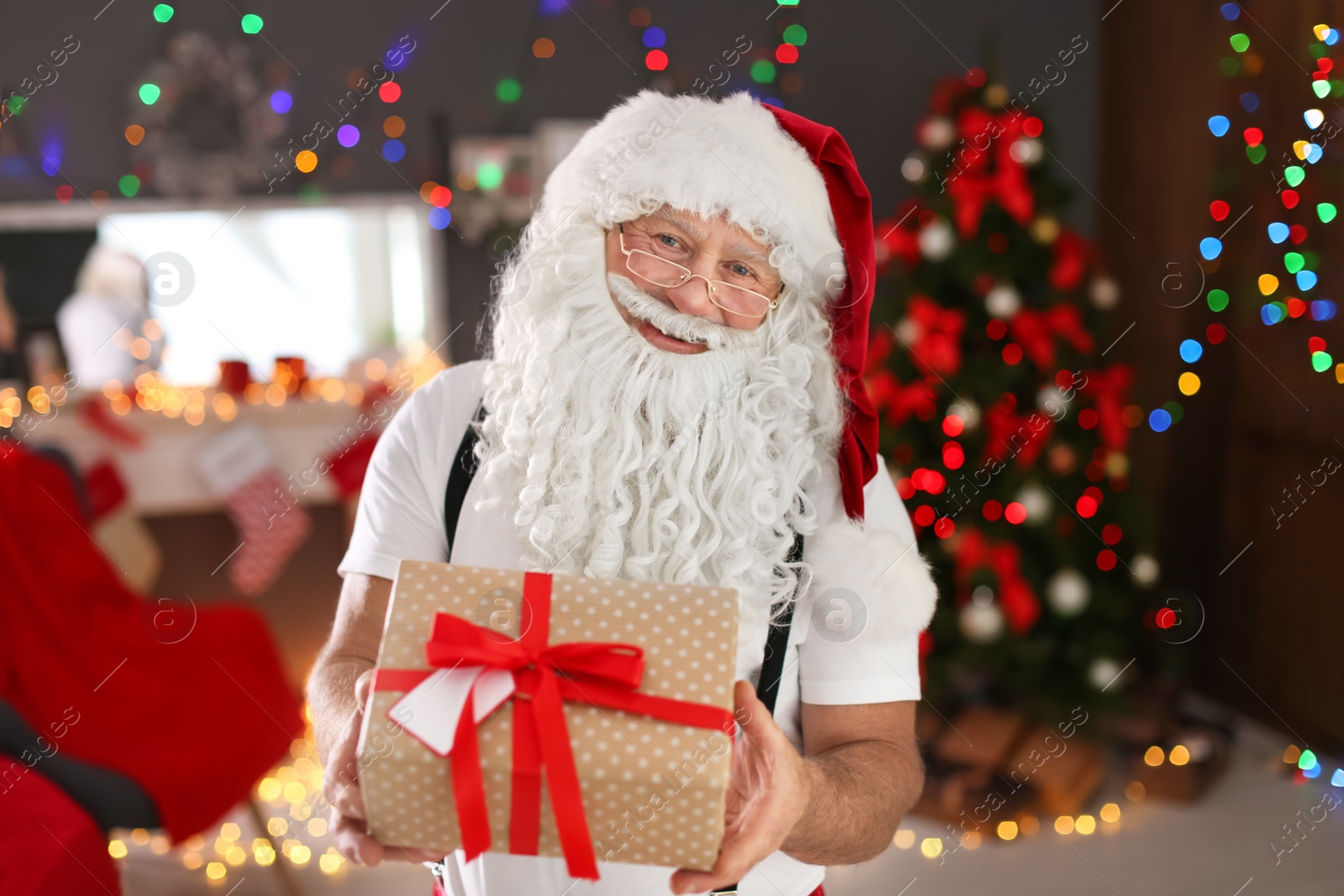 Photo of Authentic Santa Claus with gift box indoors