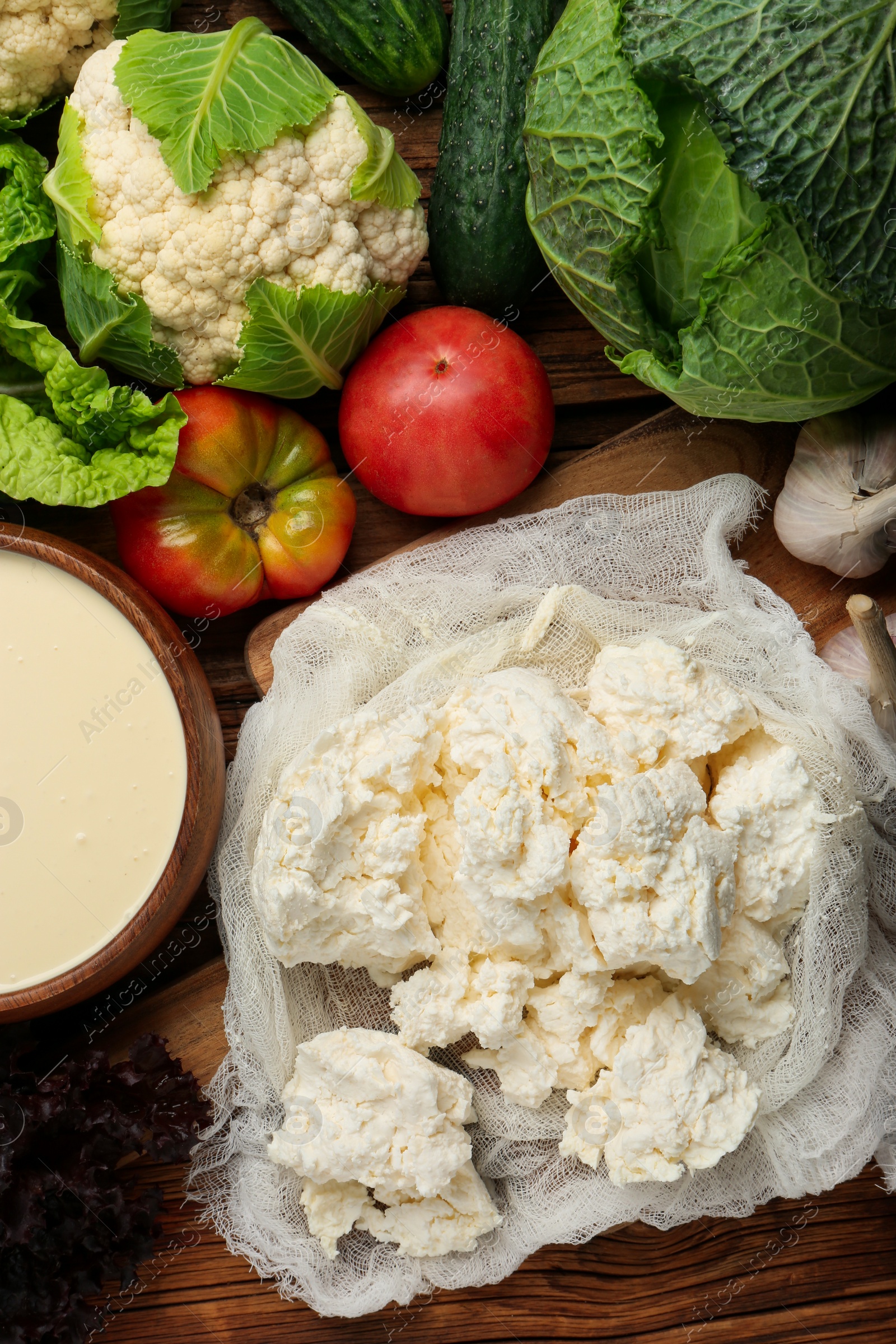 Photo of Different fresh ripe vegetables, sour cream and cottage cheese on table, flat lay. Farmer produce