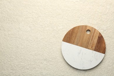Photo of Serving board on beige table, top view. Space for text