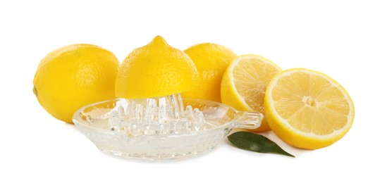 Photo of Plastic juicer and fresh lemons on white background