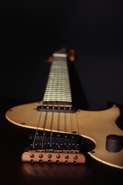 Photo of Electric guitar on black background, closeup. Musical instrument