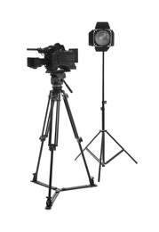 Photo of Professional video camera and lighting equipment isolated on white