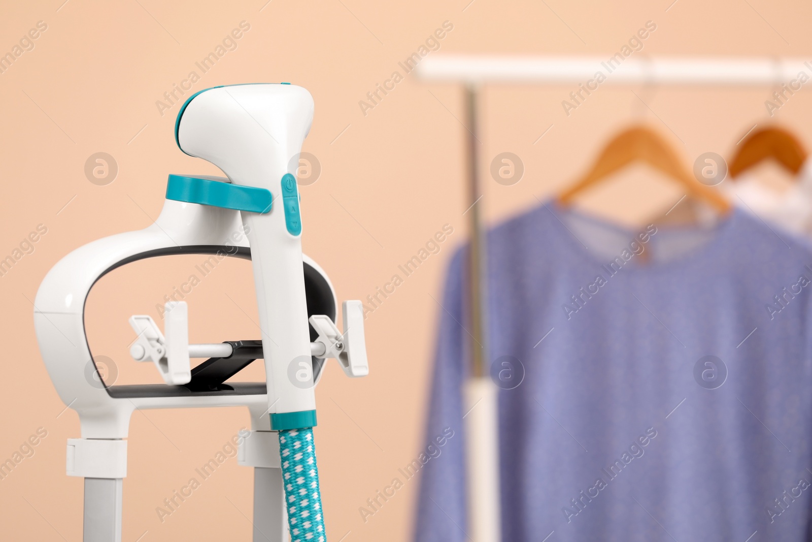 Photo of Modern steam iron at home, closeup. Space for text