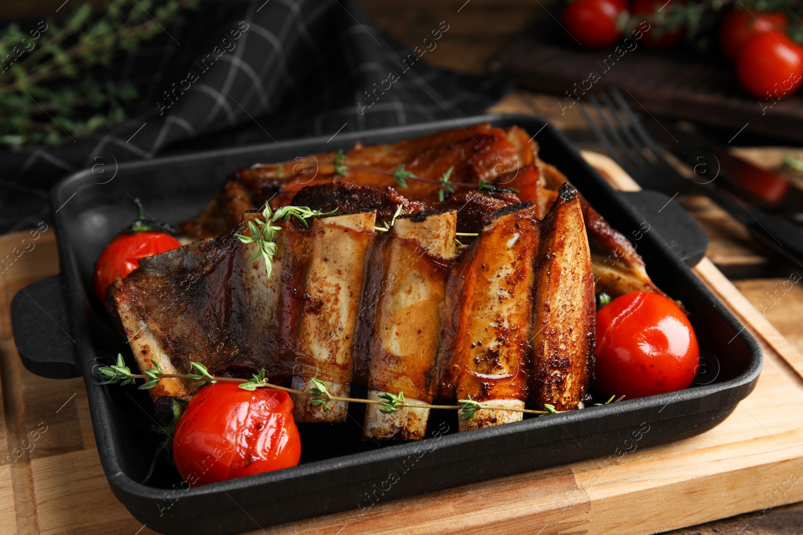 Photo of Delicious roasted ribs served on table, closeup