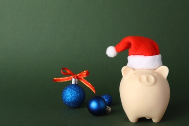 Photo of Composition with piggy bank and Christmas decor on color background. Space for text