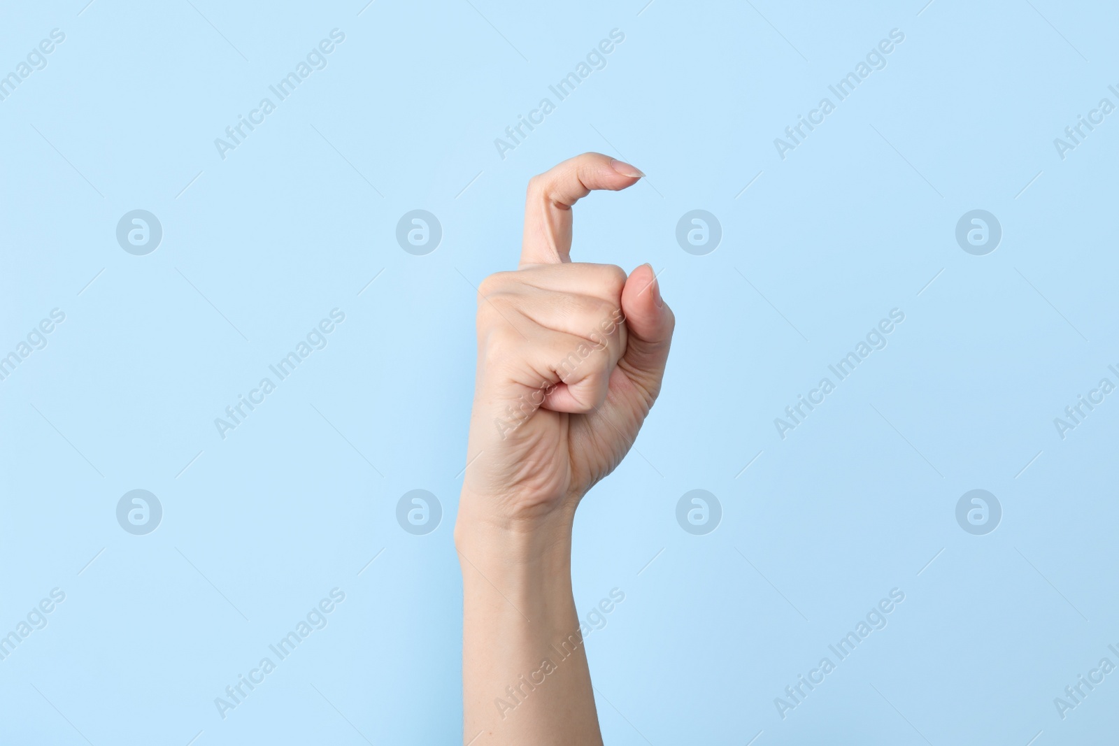 Photo of Woman showing X letter on color background, closeup. Sign language