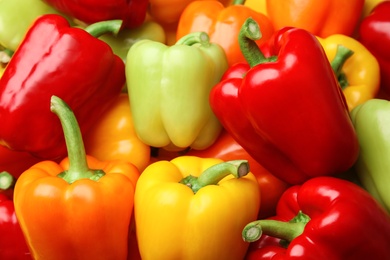 Fresh ripe colorful bell peppers as background, closeup