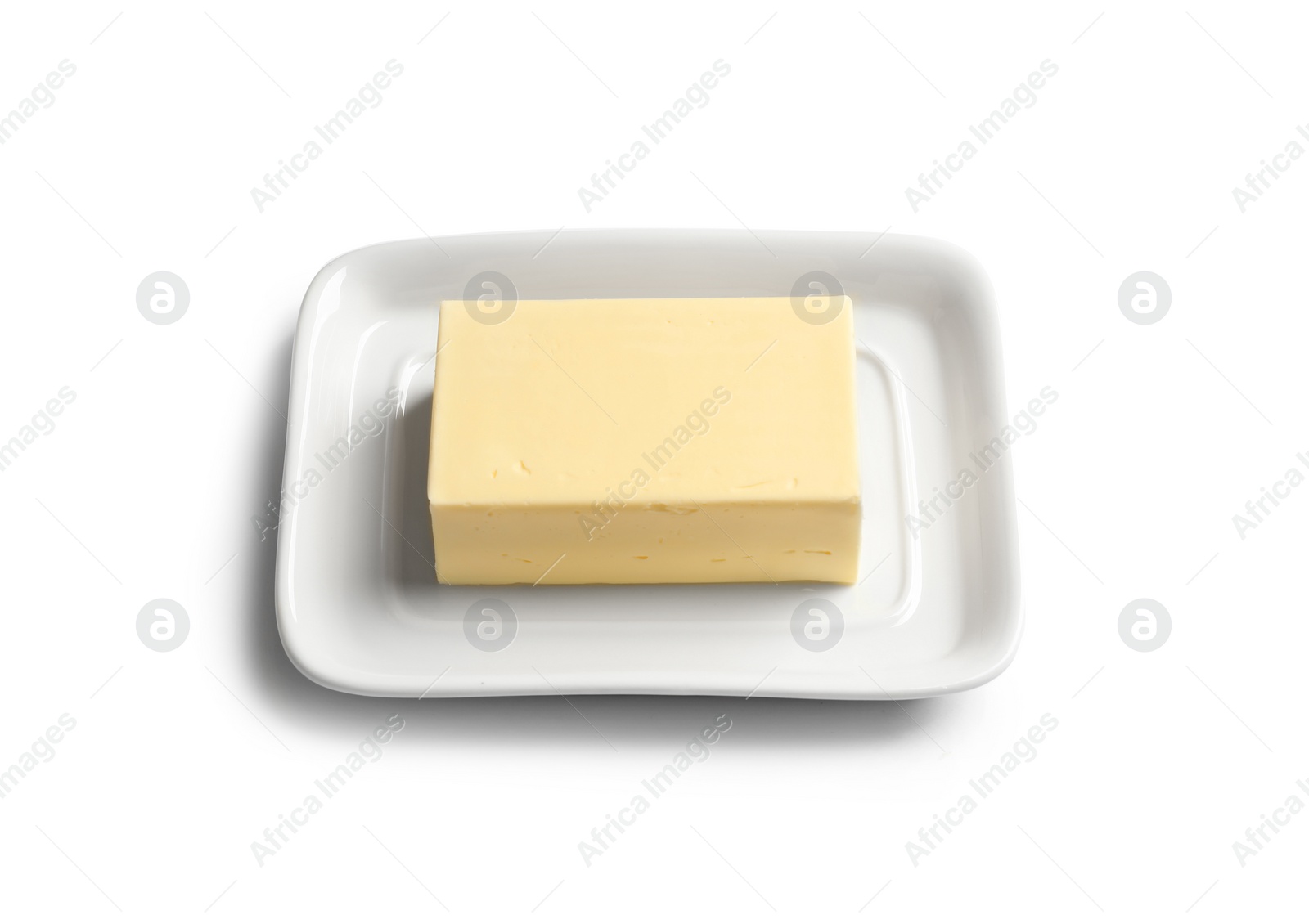 Photo of Ceramic dish with block of fresh butter on white background