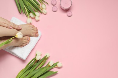 Photo of Closeup of woman with neat toenails after pedicure procedure on pink background, top view. Space for text