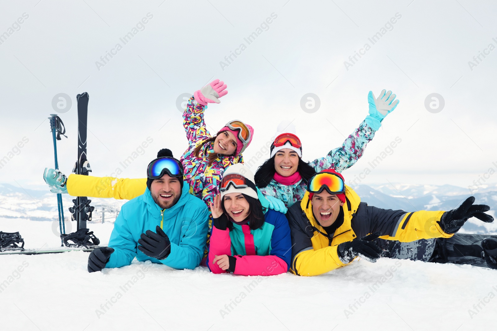 Photo of Group of friends with equipment in snowy mountains. Winter vacation