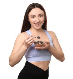 Photo of Happy woman eating tasty granola with fresh berries on white background