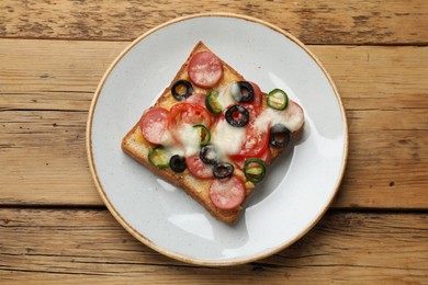 Tasty pizza toast on wooden table, top view