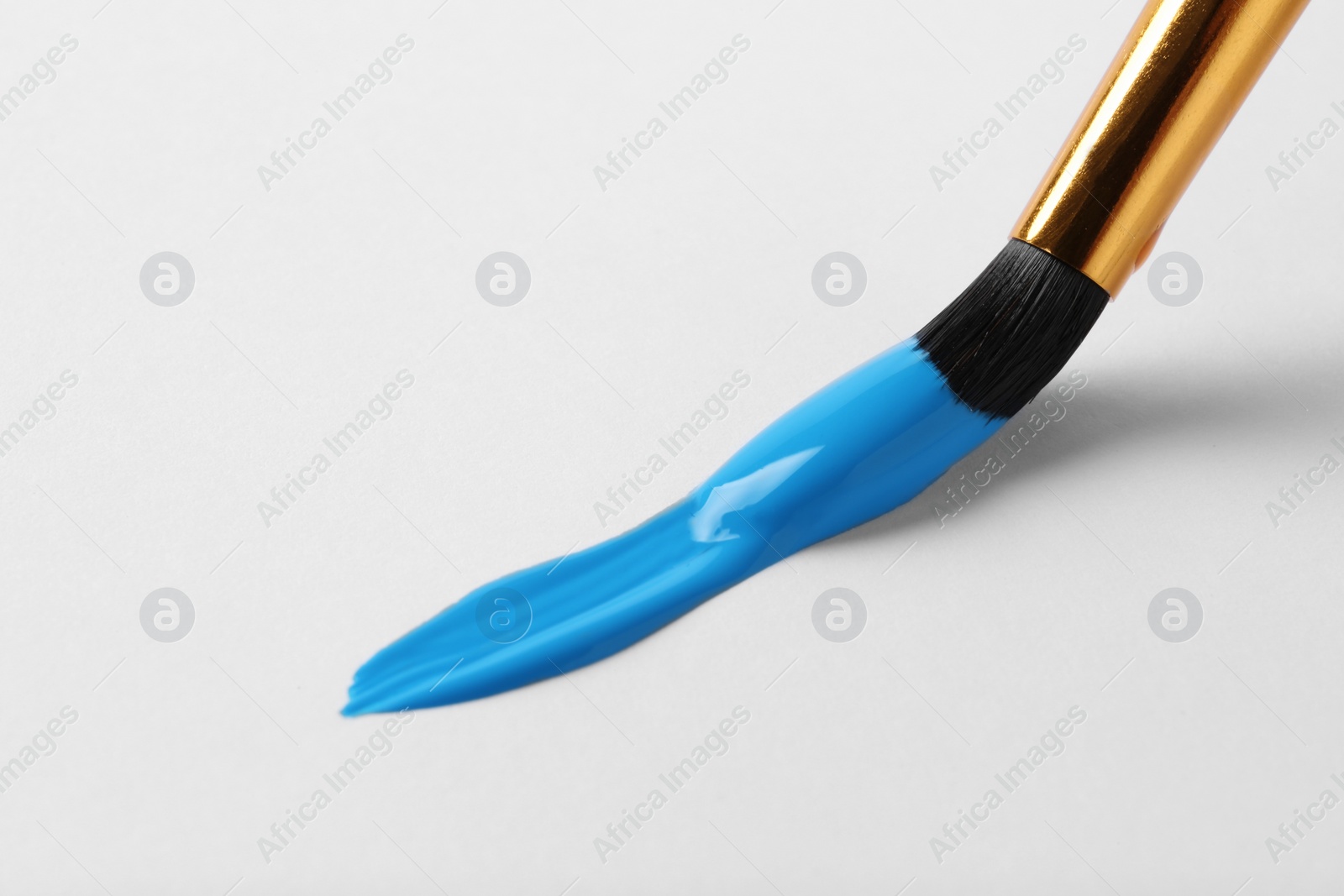 Photo of Brush with color paint and stroke on white background