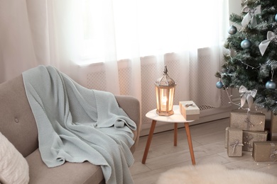 Photo of Stylish living room interior with decorated Christmas tree