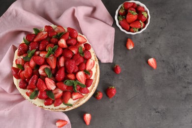 Tasty cake with fresh strawberries and mint on gray table, flat lay. Space for text